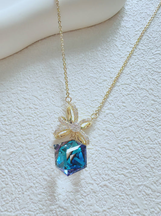 Radiant Blue Crystal Pendant Necklace – Elegant Gold Bow Design