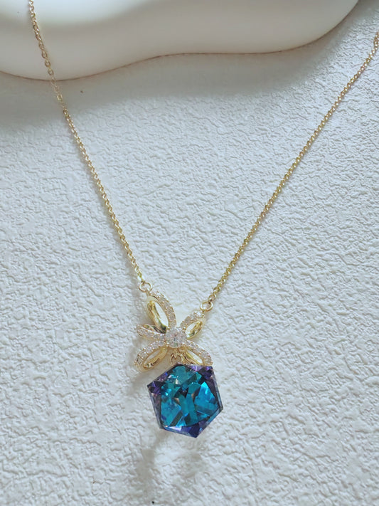 Radiant Blue Crystal Pendant Necklace – Elegant Gold Bow Design